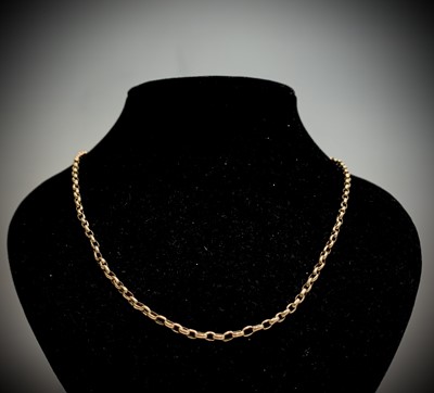 Lot 22 - A 9ct gold bracelet with flat curb links...