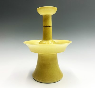 Lot 45 - A Chinese yellow glazed porcelain candlestick...