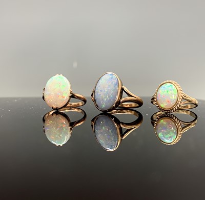 Lot 39 - Three gold rings each set an oval opal 8.5gm