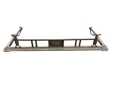 Lot 371 - An Edwardian brass fender, the central tablet...