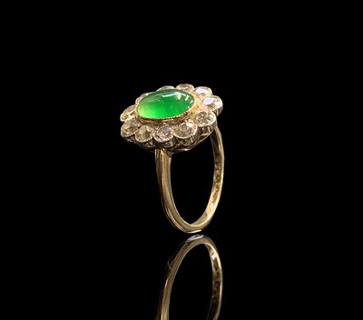 Lot 18 - A cabochon emerald and diamond oval cluster...