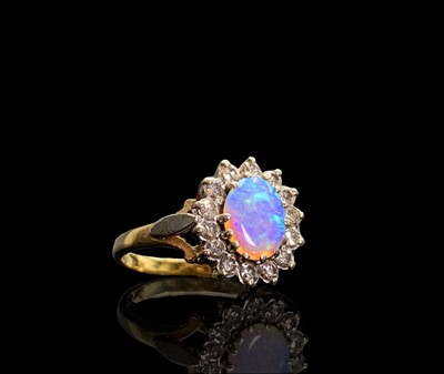 Lot 58 - An opal and diamond oval cluster ring 3.7gm