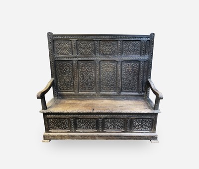 Lot 5 - A George III oak box settle, the panel back...