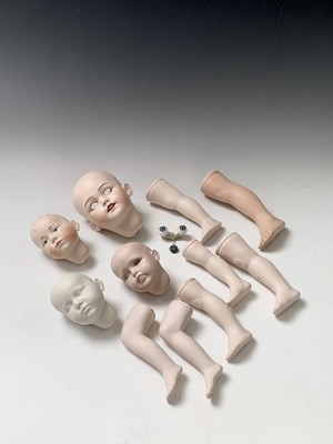 Lot 780 - Dolls - A box containing spare porcelain heads...