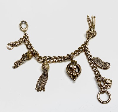 Lot 238 - A silver gilt curb link bracelet with three tassels.