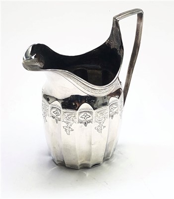 Lot 2031 - A bright cut Georgian silver helmet cream jug...