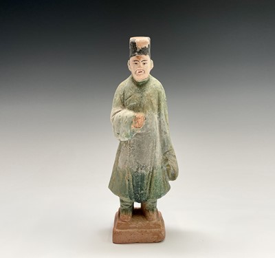 Lot 394 - A Chinese glazed pottery figure of a standing...