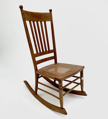 Lot 3165 - An elm rocking chair in the Arts and Crafts...