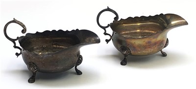 Lot 2155 - A pair of silver sauce boats each on three...
