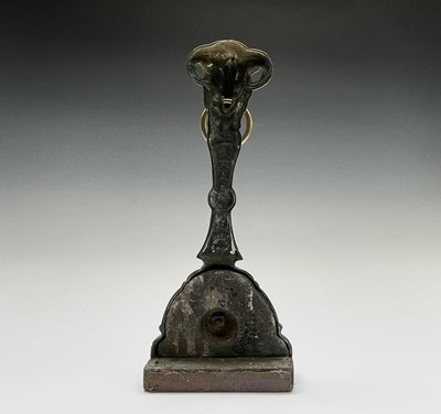Lot 152 - A brass door porter, 19th century, the rams...