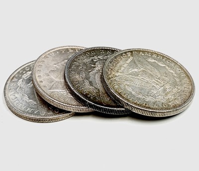 Lot 25 - USA Morgan Silver Dollars. A run of four US...