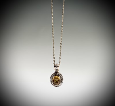 Lot 104 - A yellow sapphire (2.7cts) and diamond pendant...