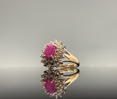 Lot 115 - A 9ct gold ring with an oval ruby and diamond...