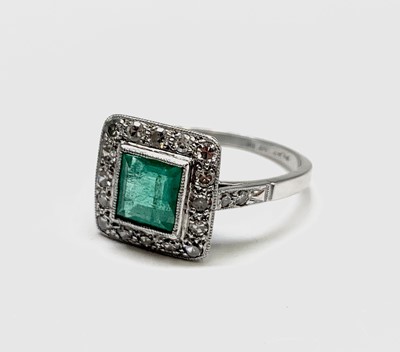 Lot 53 - A platinum emerald and diamond square ring 4.2gm