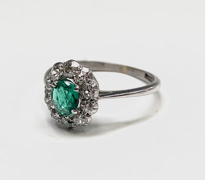 Lot 27 - An 18ct white gold emerald and diamond oval...