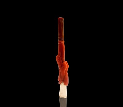 Lot 30 - A gold cheroot holder in the mouth of a red...