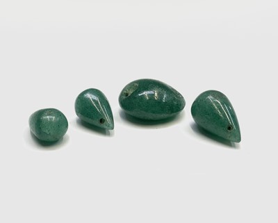 Lot 102 - Three unmounted jade teardrops and a jade bead...