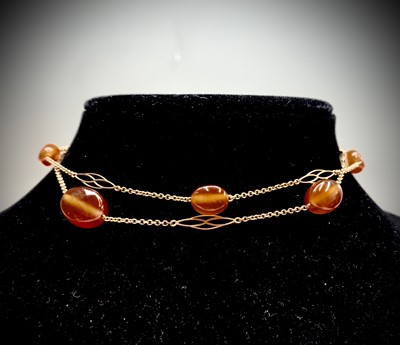 Lot 138 - A delicate gold necklace with spaced pierced...