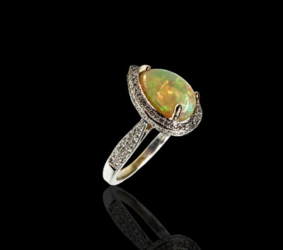 Lot 133 - An 18ct white gold ring set a pear shape opal...