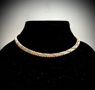 Lot 854 - A contemporary 18ct two-colour gold weave...
