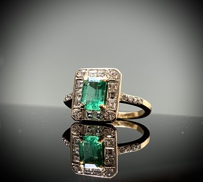Lot 112 - An emerald and diamond ring the principal...