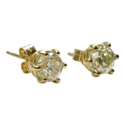 Lot 2794 - A pair of diamond earring studs, each with a...