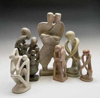 Lot 66 - A carved stone figure of a stylised family...