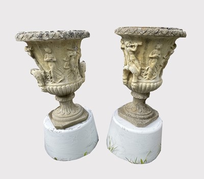 Lot 669 - A pair of reconstituted stone garden urns of...