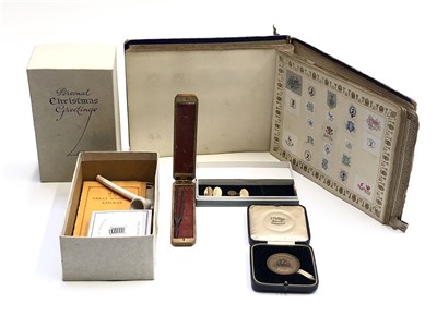 Lot 553 - An album of crests and monograms, together...