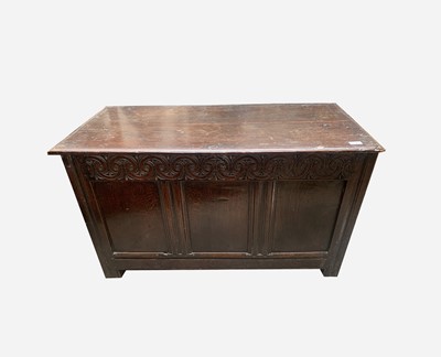 Lot 24 - A carved oak coffer, 17th century, with scroll...