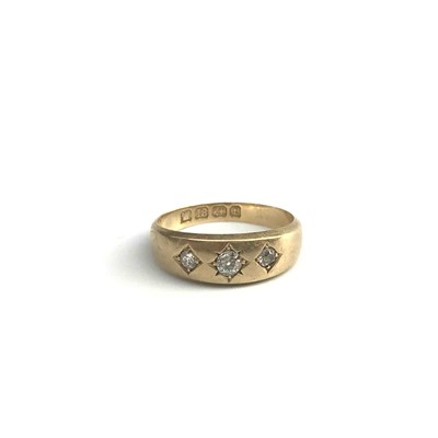 Lot 2769 - An 18ct gold ring gypsy set 3 diamonds