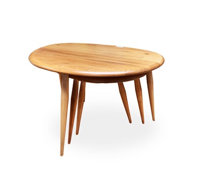 Lot 3057 - A nest of three Ercol light elm pebble...