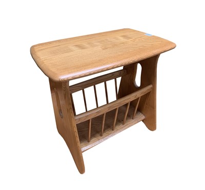 Lot 3058 - An Ercol light elm magazine rack and...