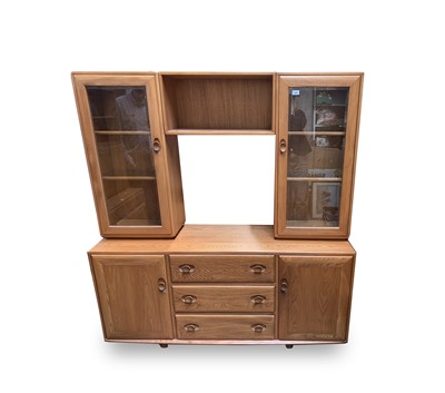Lot 3059 - An Ercol light elm side sideboard cabinet, the...