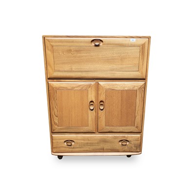 Lot 3063 - An Ercol light elm bureau or writing cabinet,...