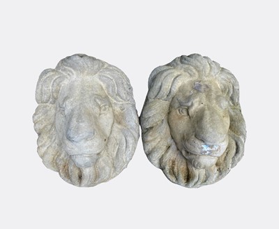 Lot 602 - A pair of composition stone lion wall masks....