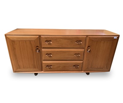 Lot 3068 - An Ercol light elm sideboard, fitted three...