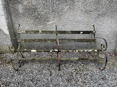 Lot 646 - A garden bench with three wrought iron...