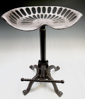 Lot 3104 - A cast iron tractor seat style stool, with...