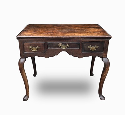 Lot 82 - A George III oak lowboy, with three frieze...
