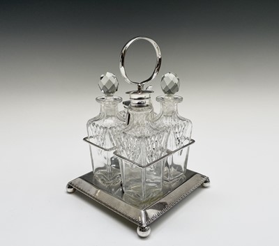 Lot 124 - An Edwardian four bottle cruet, on silver...