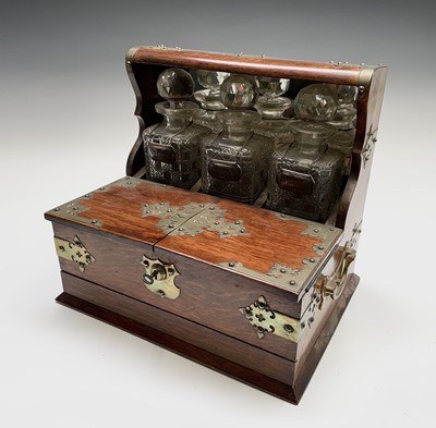 Lot 112 - An Edwardian tantalus, fitted with three...