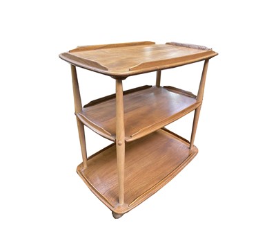 Lot 3109 - An Ercol light elm three tier trolley, with...