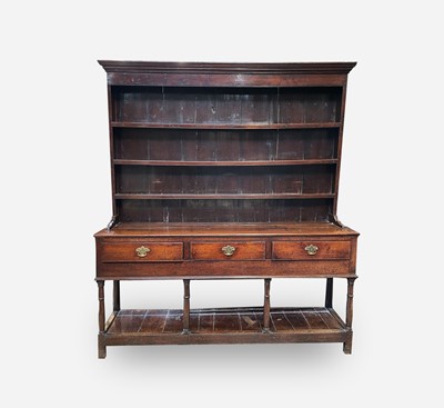 Lot 25 - A George III oak dresser, the rack with three...