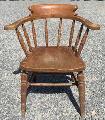 Lot 147 - An elm and beech smokers bow armchair, early...