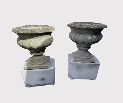 Lot 662 - A pair of composition garden urns on...