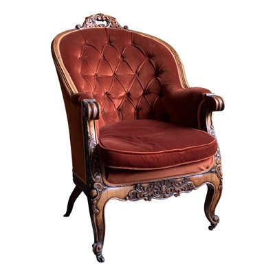 Lot 3389 - A carved walnut buttoned armchair.