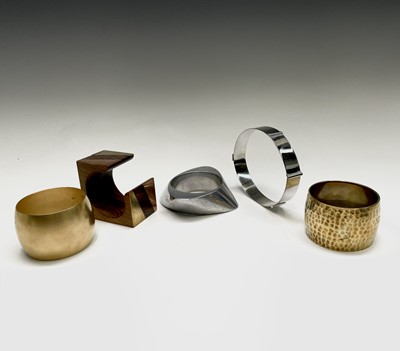 Lot 189 - Four modernist bangles in cast aluminium,...