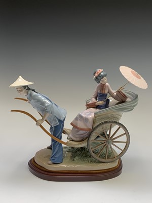 Lot 985 - A Lladro figure group, modelled as a geisha...