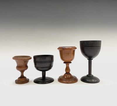 Lot 155 - Four Victorian treen goblets, heights 12, 10,...